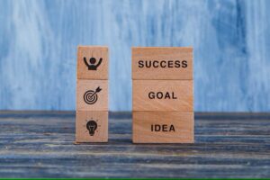 Business strategy concept with wooden blocks wooden grungy blue background side view 176474 7644 (1)